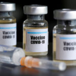 FILE PHOTO: Small bottles labeled with a “Vaccine COVID-19” sticker and a medical syringe are seen in this illustration
