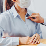 Doctor wear face mask and eyeglasses Measuring arterial blood pressure woman patient helping, encourage and empathy at nursing hospital ward After Corona virus epidemic.