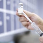 Female nurse filling syringe