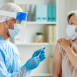 Side,View,Shot,Of,Male,Nurse,Wearing,Protective,Mask,And