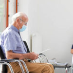 Senior,Woman,And,Man,Sitting,With,Face,Masks,In,A