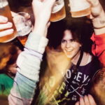 A group of girls saying cheers and are having ice cold drafted beer at the local nightclub. Denmark 2012.