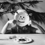 Little girl wearing a reindeer mask 