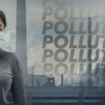 Caucasian woman wearing the respiratory protection mask against air pollution and dusk with factories on background