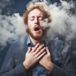 A man, furious and in discomfort, experiences the adverse effects of vaping, coughing and feeling dizzy, highlighting the problems associated with this habit.