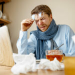 Sick man while working in office, businessman caught cold, seasonal flu.