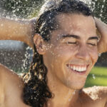 smiley-man-taking-shower-outside-front-view