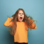 The surprise. Teen girl on a blue background. Facial expressions and people emotions concept