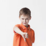 angry-little-boy-showing-dislike-gesture-white-backdrop