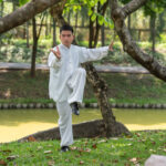 asian-man-working-out-with-tai-chi-morning-park-chinese-martial-arts