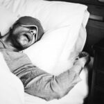 A man sleeping on a bed