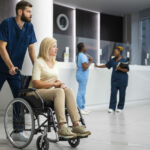 nurse-helping-patient-wheelchair-side-view