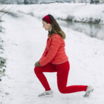 side-view-young-woman-stretching-her-leg-winter