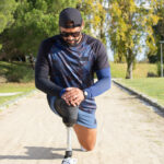 Sporty man with artificial leg getting ready for jog
