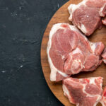 top-view-fresh-meat-slices-raw-meat-round-wooden-desk-dark-food-freshness-animal-cow-food-kitchen