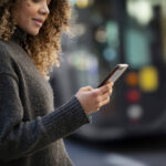 young-woman-using-her-smartphone-city