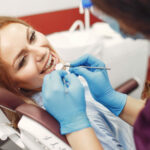 Beautiful girl sitting in the dentist’s office