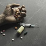 The man committing suicide by overdosing on medication. Close up