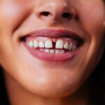 Creative studio portrait of beautiful hispanic woman with diastema