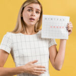 woman-mimicking-stomach-cramps-from-menstruation