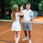 young-couple-tennis-court-handsome-man-attractive-woman-give-five