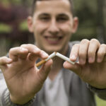 Young man refuses to smoke and breaks cigarette